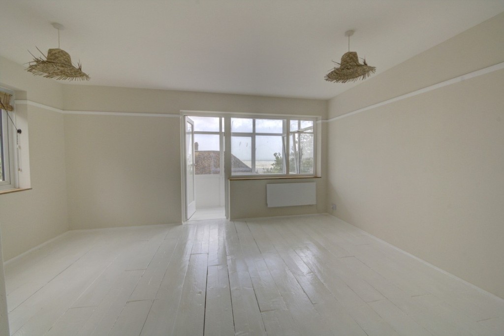 Lot: 147 - TWO-BEDROOM APARTMENT WITH SEA VIEWS - Flat 1 - living room before tenant moved in provided by the seller